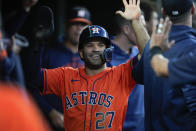 Houston Astros' Jose Altuve (27) celebrates scoring against the Detroit Tigers in the eighth inning of a baseball game, Friday, May 10, 2024, in Detroit. (AP Photo/Paul Sancya)