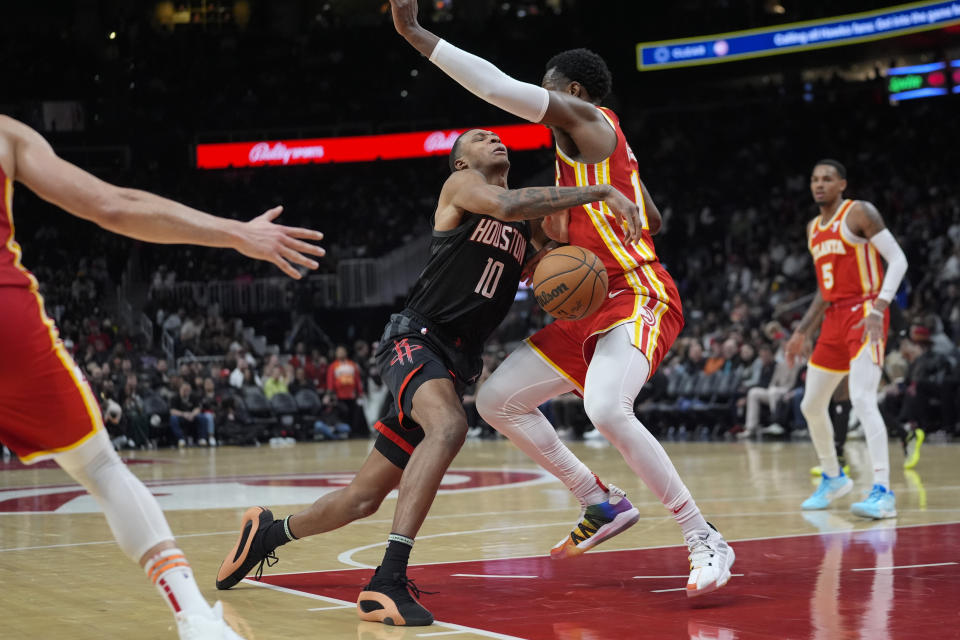 Houston Rockets forward Jabari Smith Jr. (10) loses control of the ball as he drives against Atlanta Hawks forward Onyeka Okongwu (17) during the first half of an NBA basketball game Saturday, Feb. 10, 2024, in Atlanta. (AP Photo/John Bazemore)