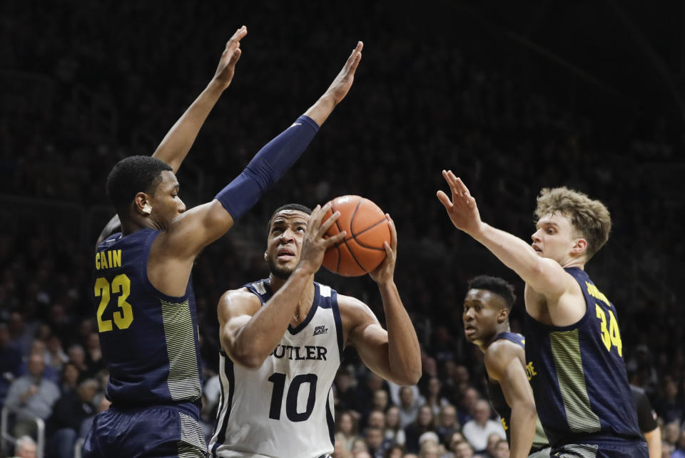 Butler's Bryce Nze (10) shoots against Marquette's Jamal Cain (23) and Jayce Johnson (34) during the first half of an NCAA college basketball game, Friday, Jan. 24, 2020, in Indianapolis. (AP Photo/Darron Cummings)