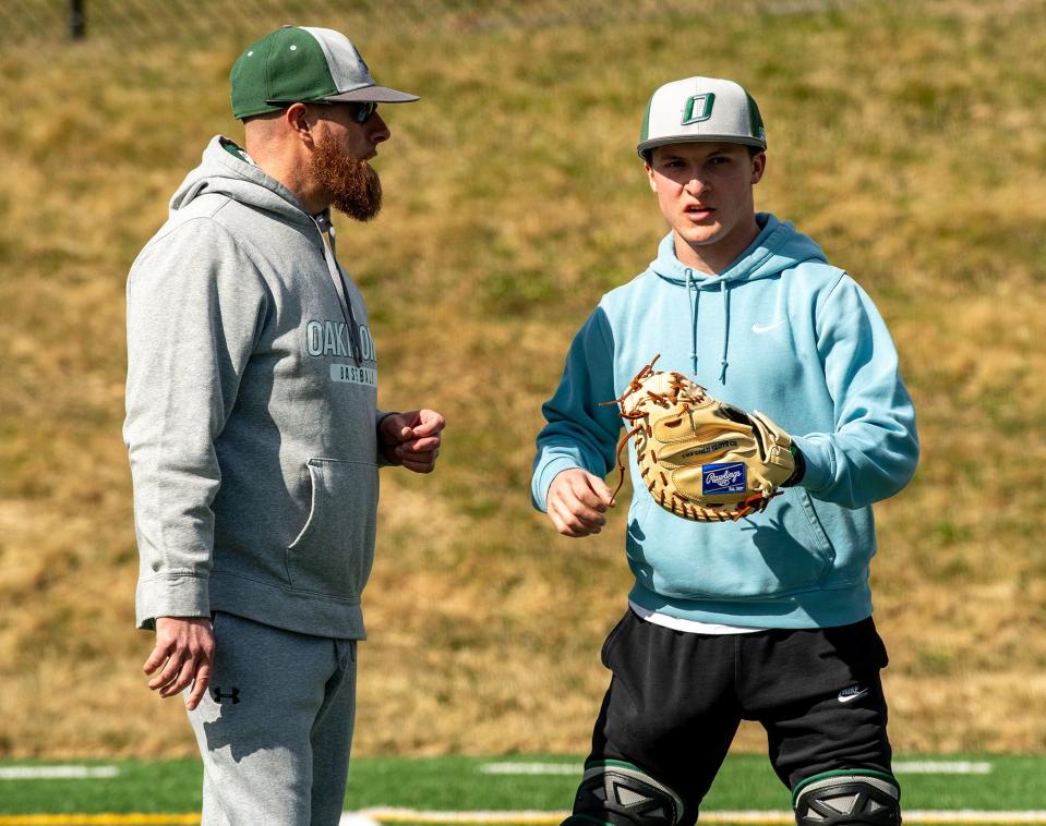 Oakmont baseball head coach Tim Caouette talks with catcher Johnny Losordo on the first day of practice Monday, March 18, 2024.