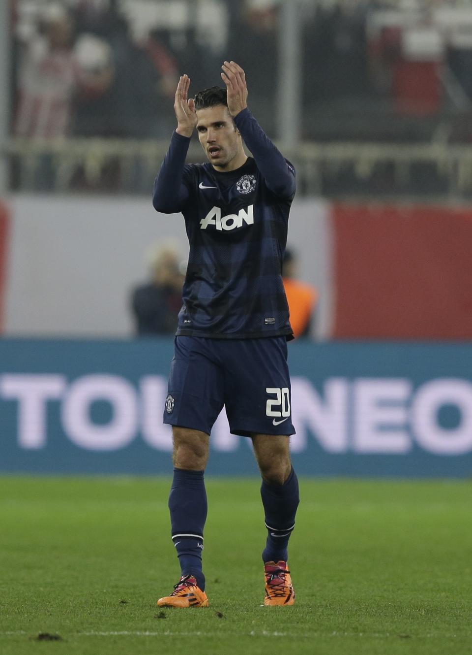 Manchester United's Robin van Persie applauds the fans of his team after a Champions League, round of 16, first leg soccer match against Olympiakos at Georgios Karaiskakis stadium, in Piraeus port, near Athens, on Tuesday, Feb. 25, 2014. Olympiakos won 2-0. (AP Photo/Thanassis Stavrakis)