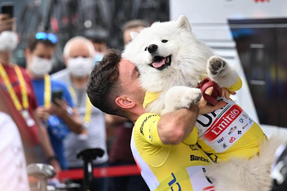 British Adam Yates of UAE Team Emirates and his dog wearing the yellow jersey of leader in the overall ranking pictured at the start of the second stage of the Tour de France cycling race a 2089 km race from VitoriaGasteiz to San Sebastian Spain Sunday 02 July 2023 This years Tour de France takes place from 01 to 23 July 2023 BELGA PHOTO JASPER JACOBS Photo by JASPER JACOBS  BELGA MAG  Belga via AFP Photo by JASPER JACOBSBELGA MAGAFP via Getty Images