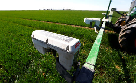 Optical sensors, Trimble Navigation Ltd’s 'GreenSeeker' devices to instantly adjust nitrogen fertilization, are seen installed at a tractor in a wheat field in the Bavarian town of Irlbach near Deggendorf, Germany, April 21, 2016. REUTERS/Michaela Rehle