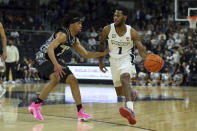 Providence's Al Durham (1) is defended by Georgetown's Dante Harris (2) during the first half of an NCAA college basketball game Thursday, Jan. 20, 2022, in Providence, R.I. (AP Photo/Stew Milne)