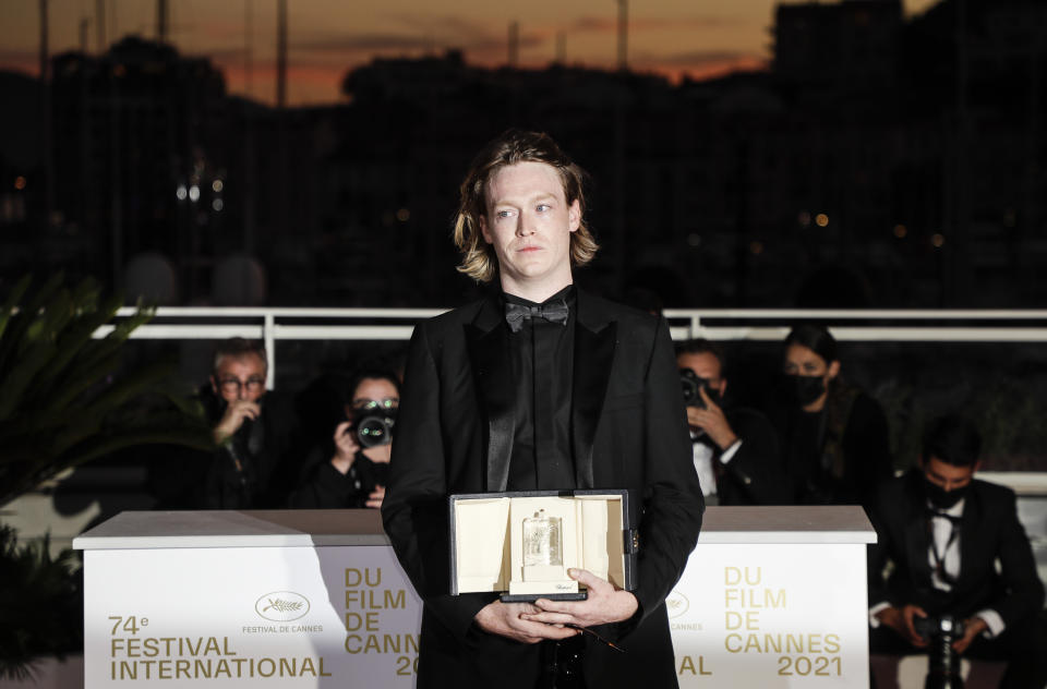 Caleb Landry Jones poses for photographers with the award for best actor for the film' Nitram' during the awards ceremony at the 74th international film festival, Cannes, southern France, Saturday, July 17, 2021. (Photo by Vianney Le Caer/Invision/AP)