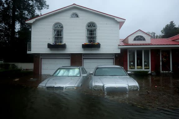 Florence's flooding claims a couple of cars and the first story of a house in New Bern, NC.