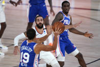 Philadelphia 76ers guard Raul Neto (19) looks to pass to teammate guard Shake Milton, right, as Phoenix Suns guard Ricky Rubio (11) defends during the second half of an NBA basketball game Tuesday, Aug. 11, 2020, in Lake Buena Vista, Fla. (AP Photo/Ashley Landis, Pool)