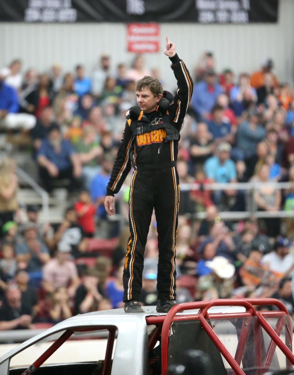 Outlaw driver Michael Harper acknowledges the crowd prior to the second of two Monster Truck Wars shows Saturday night at the Somervell County Expo Center.