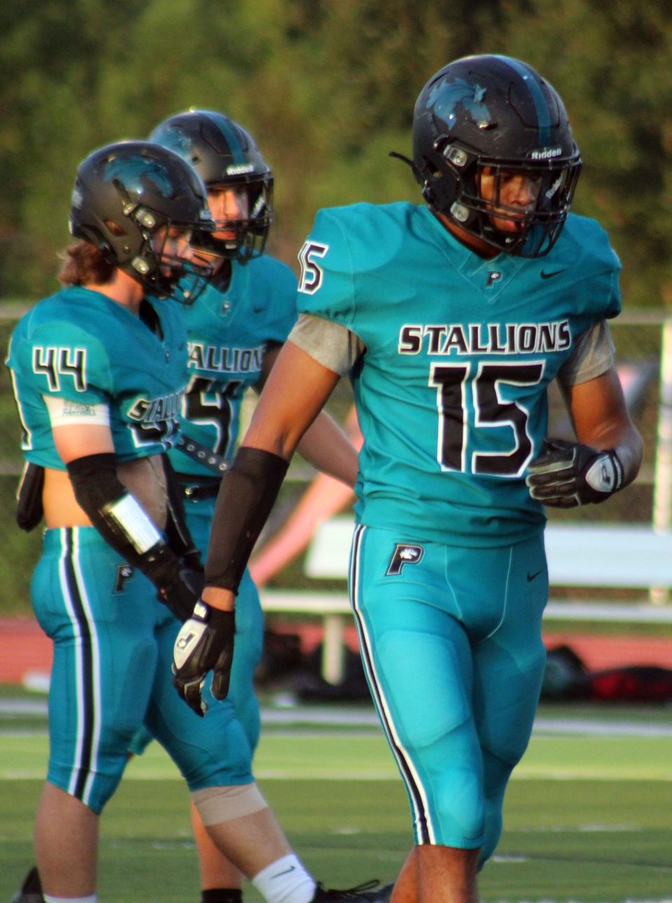 Providence defensive end Sam Hayward (15) prepares to huddle with teammates before a high school football game against Hilliard on October 5, 2023. [Clayton Freeman/Florida Times-Union]