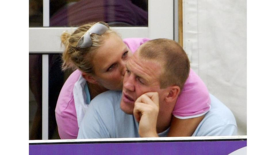 Zara Phillips in a pink top kissing Mike Tindall on the cheek