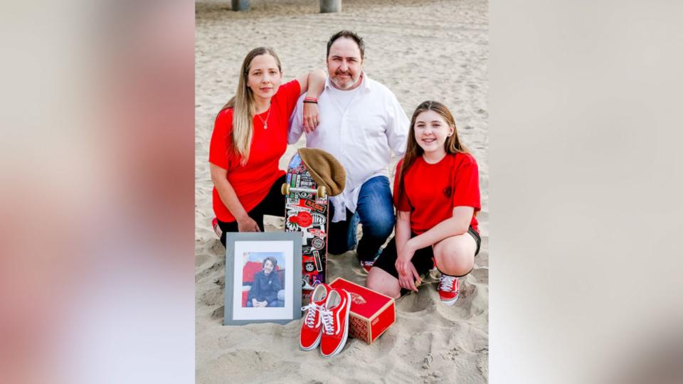 PHOTO: Alexander Neville's parents and sister pose with a photo of him and some of his favorite belongings. (Gayle Dawn Photography)