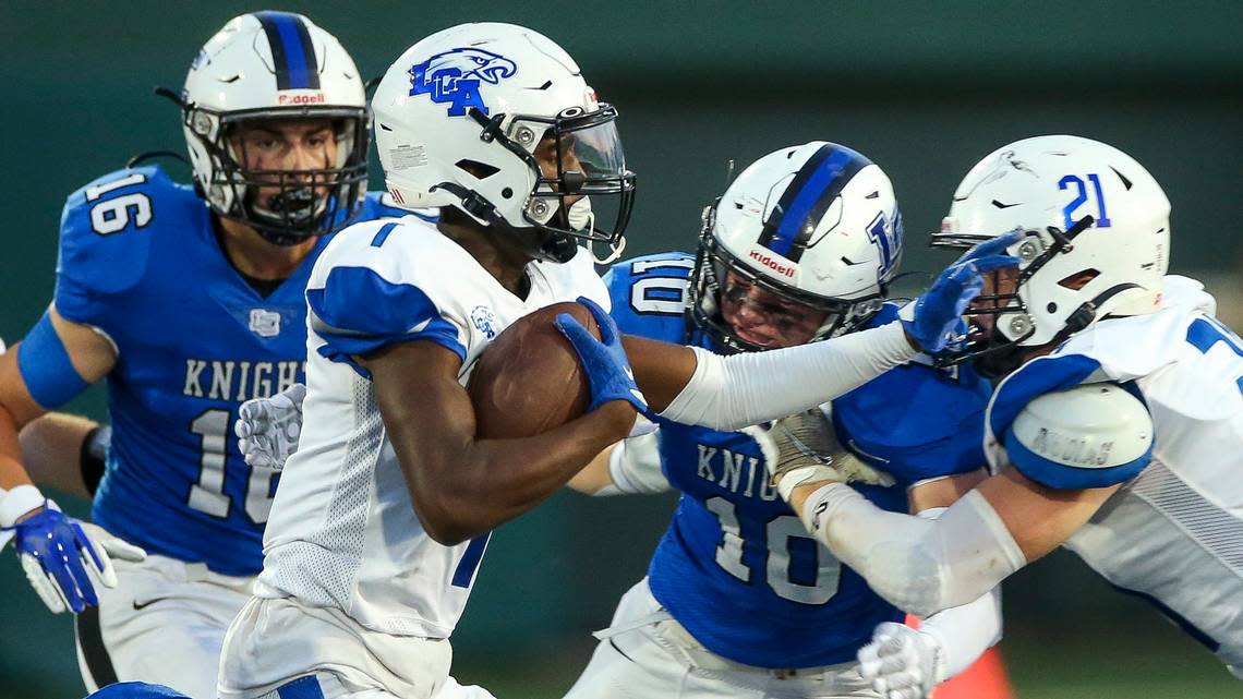 Lexington Catholic’s Hayden Dawahare, left, and Corbin Perry (10) pursued Lexington Christian’s Evan Brown (1) during their annual “Holy War” high school football rivalry game last season. The teams meet this year on Sept. 15. Brian Simms/bsimms@herald-leader.com