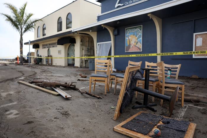 Fallen tables and chairs outside a restaurant.