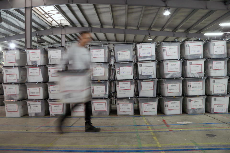 A worker carries a ballot box at Central Election Committee counting center in Fushe Kosove, Kosovo on Monday, Oct. 7, 2019. Kosovo's opposition parties have won a snap election, overcoming the former independence fighters who have governed the country since its war 20 years ago. With 96% of the votes counted Monday the left-wing Movement for Self-Determination Party, or LVV, has 26% of the votes, one percentage point more than the conservative Democratic League of Kosovo, or LDK, also formerly in opposition. (AP Photo/Visar Kryeziu)