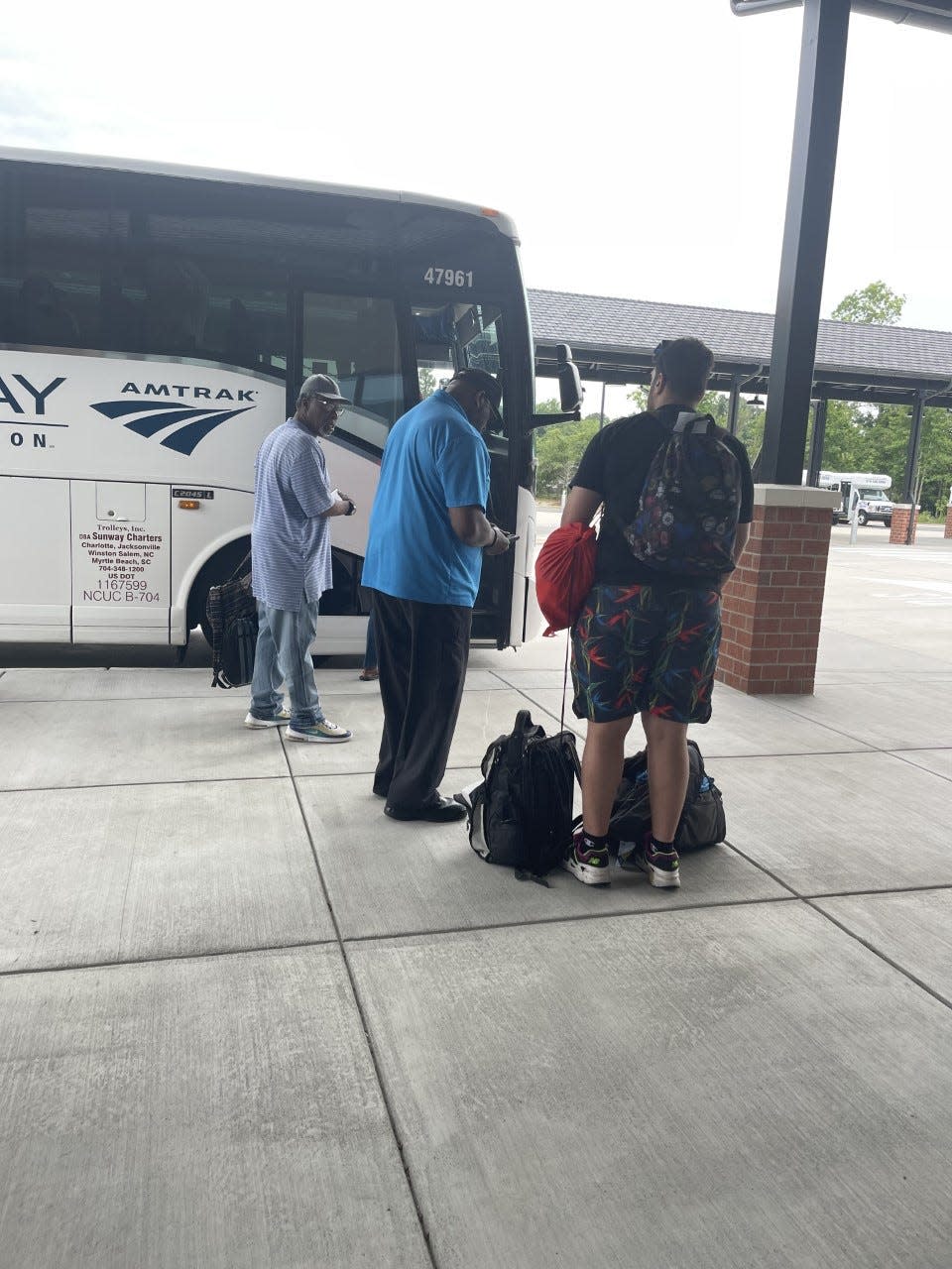 Passengers line up to board the Amtrak Thruway bus that will take them to various train stations such as Wilson.