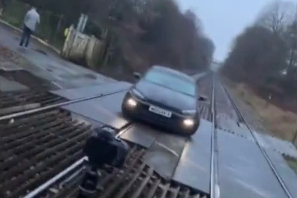 <p>A still from the video of a car parked at a level crossing in Bolton</p> (TikTok)