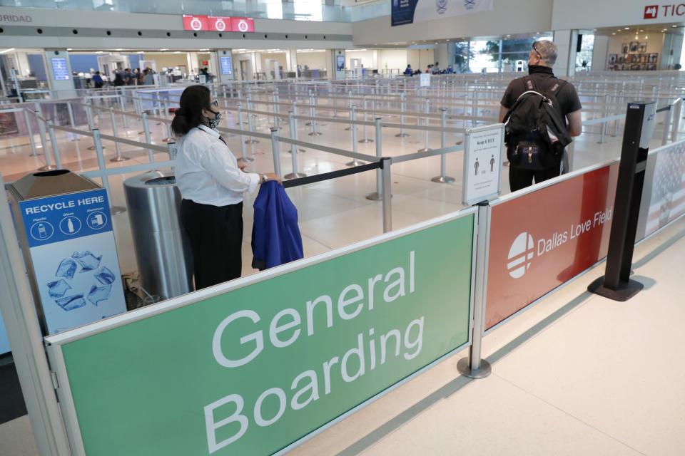 A passenger enters the general boarding line for a flight out of Love Field during the coronavirus pandemic in Dallas, Wednesday, June 24, 2020. (AP Photo/Tony Gutierrez)