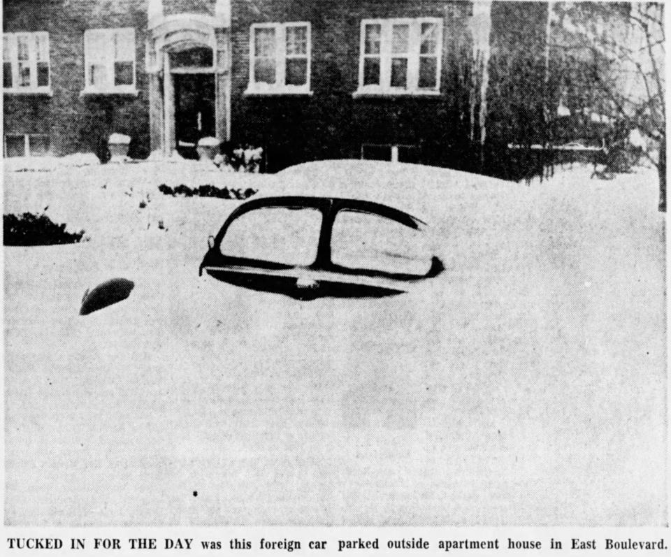 A car buried in snow on March 14, 1960 .