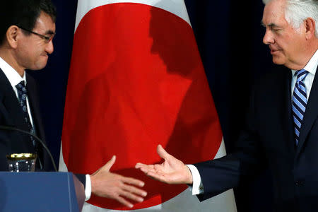 Japan's Foreign Minister Taro Kono (L) and U.S. Secretary of State Rex Tillerson shake hands at the end of a news conference after their U.S.-Japan Security talks at the State Department in Washington, U.S., August 17, 2017. REUTERS/Jonathan Ernst