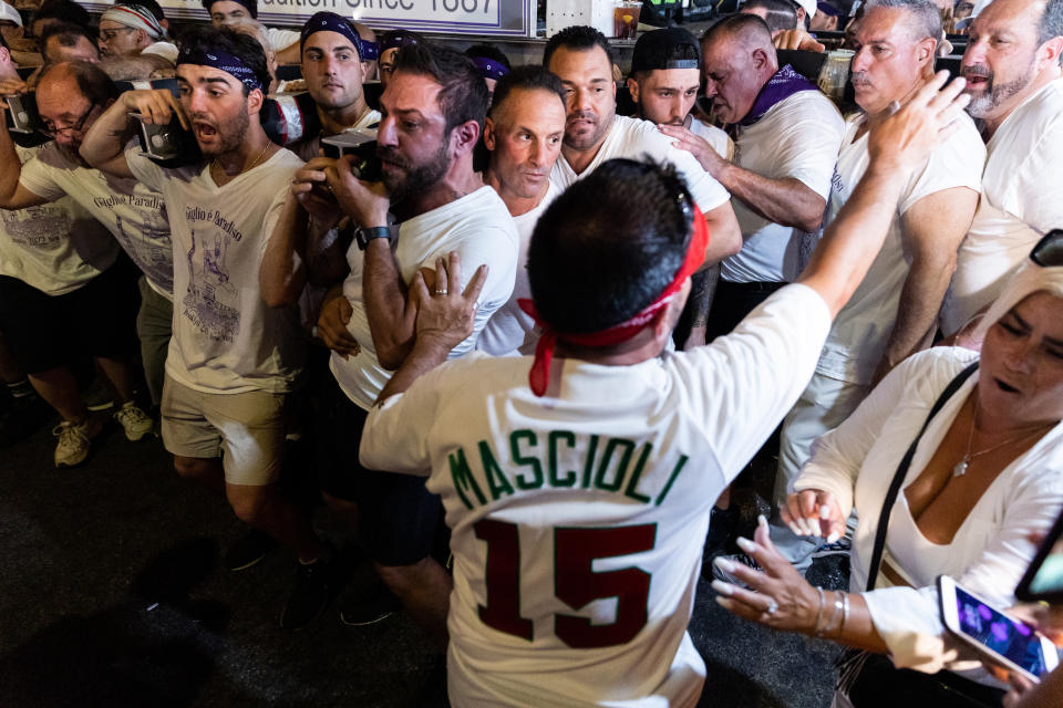 Lifters carry the 80-foot tall, 4-ton Giglio tower down Williamsburg's Havemeyer Street during the Giglio feast to recreate the return of St. Paulinus, the Bishop of Nola, Italy, Wednesday, July 13, 2012, in the Brooklyn borough of New York. (AP Photo/Julia Nikhinson)