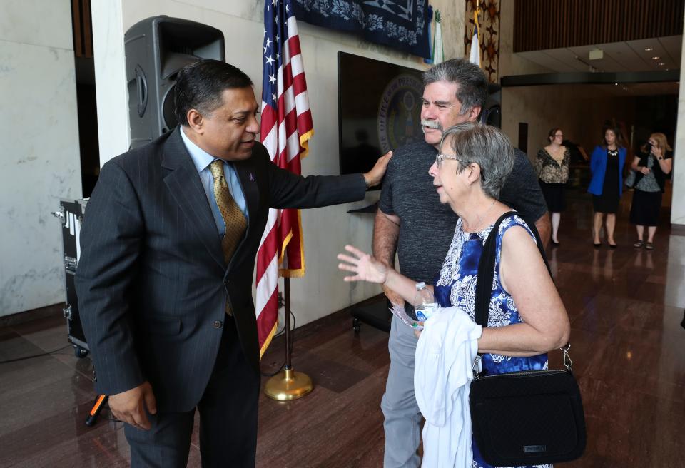 Director of the Office of National Drug Control Policy Dr. Rahul Gupta, left, spoke with Cece Brown, right, and her husband Bobby Brown following a roundtable discussion with public health officials, law enforcement, business and faith leaders and university presidents as they gave an overview of the current state of the overdose epidemic in West Virginia at the Culture Center in Charleston, W.Va. on Aug. 18, 2022.  The Browns’ son Ryan Brown died at age 27 from a drug overdose. They have been instrumental in the passage of the Prevention and Recovery Fund Act in West Virginia.