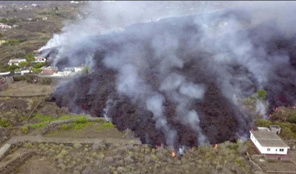 In this image made from video provided by OVERON, lava is seen after a volcanic eruption in La Palma, Spain, Monday, Sept. 20, 2021. Giant rivers of lava are tumbling slowly but relentlessly toward the sea after a volcano erupted on a Spanish island off northwest Africa. The lava is destroying everything in its path Monday, but prompt evacuations helped avoid casualties after Sunday's eruption. (OVERON via AP)