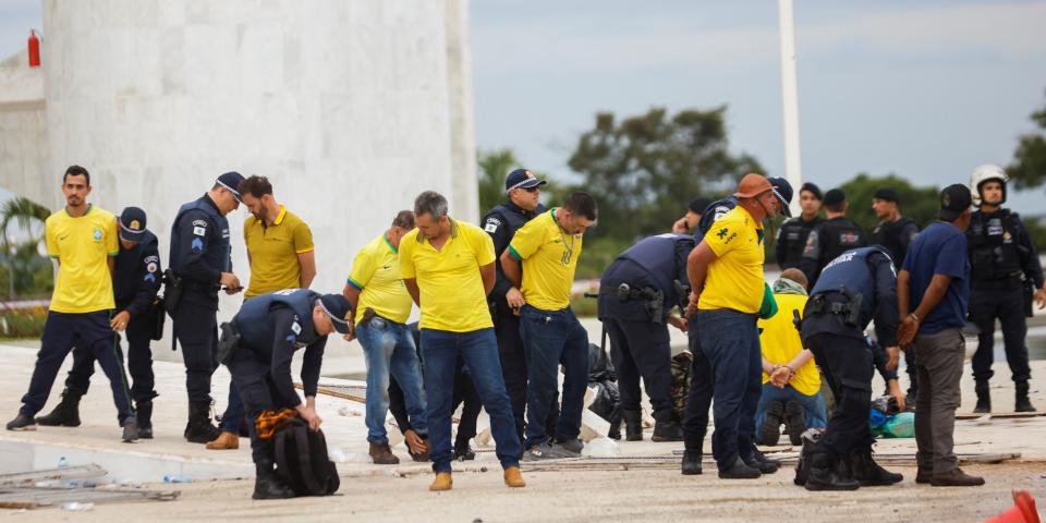 Security forces detain supporters of Brazil's former President Jair Bolsonaro during a demonstration against President Luiz Inacio Lula da Silva, in Brasilia, Brazil, January 8, 2023.