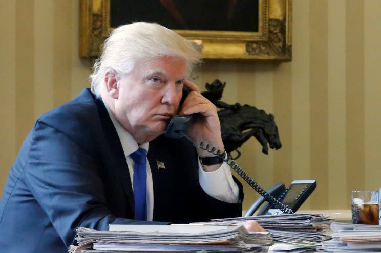 Trump listens during a phone call with Russian President Vladimir Putin in January. (Jonathan Ernst/Reuters)