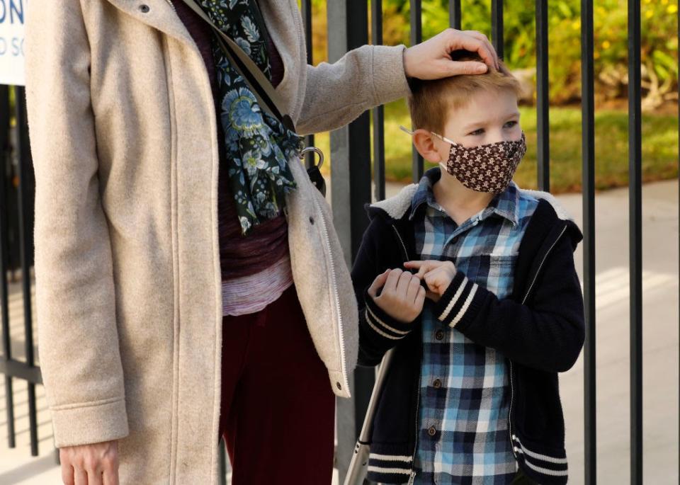 Feb. 2: First grade student Felix Fuchs with his Mom Kate Fuchs waits to have his temperature taken when he arrives at Alta Vista Elementary School in Redondo Beach, California. (Getty Images)
