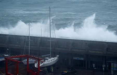 Waves crash on a wall at the port of Angra do Heroismo in Azores