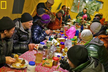 The team gathers for dinner in the mess tent. Photo by Andy Bardon/National Geographic