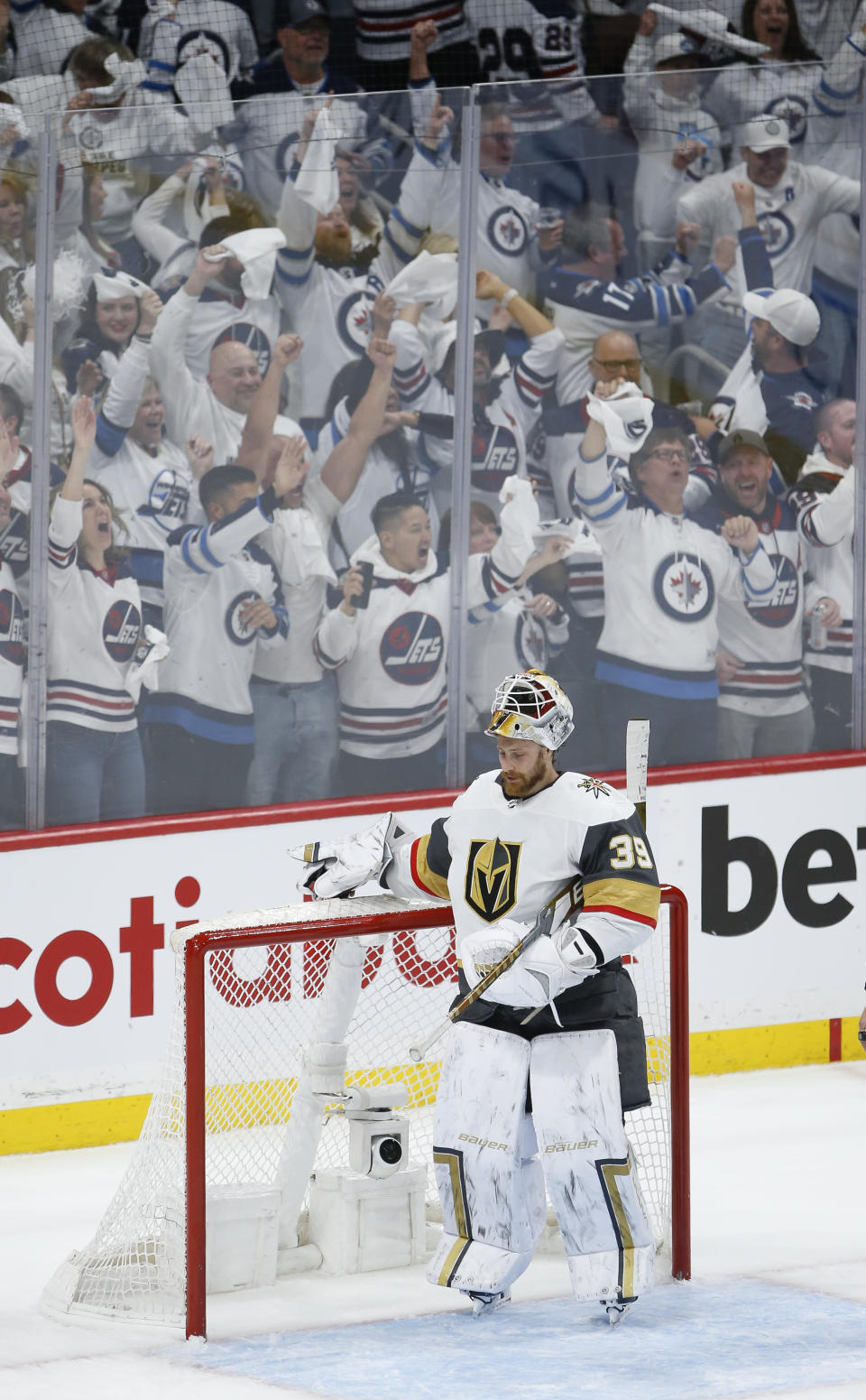 Winnipeg Jets fans celebrate Adam Lowry's (17) game-tying goal past Vegas Golden Knights goaltender Laurent Brossoit (39) late in the third period of Game 3 of an NHL hockey Stanley Cup first-round playoff series, Saturday, April 22, 2023, Winnipeg, Manitoba. (John Woods/The Canadian Press via AP)