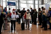 Travellers arrive at Kuala Lumpur International Airport under the Malaysia-Singapore Vaccinated Travel Lane programme, in Sepang
