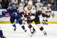 Ottawa Senators left wing Brady Tkachuk (7) skates around Tampa Bay Lightning left wing Brandon Hagel (38) during the first period of an NHL hockey game Thursday, April 11, 2024, in Tampa, Fla. (AP Photo/Chris O'Meara)