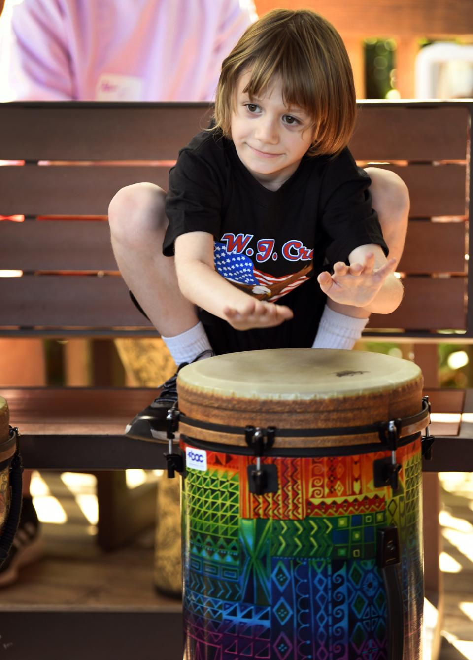 William, a student of W.J. Creel Elementary in Melbourne, tries out the drums under the instruction of Charles Baumgartner at the BAC (Brevard Achievement Center) 39th annual Color in Motion Art Festival at Brevard Zoo this past week.
(Credit: TIM SHORTT/ FLORIDA TODAY)