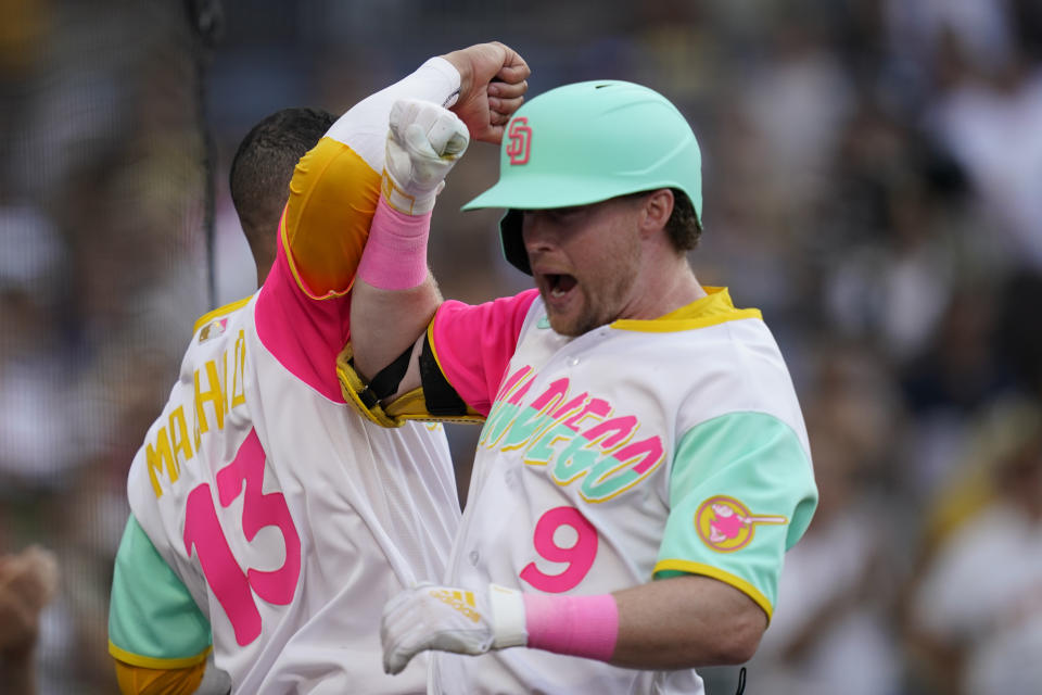 San Diego Padres' Jake Cronenworth, right, celebrates with Manny Machado after hitting a home run against the Arizona Diamondbacks during the second inning of a baseball game Wednesday, Sept. 7, 2022, in San Diego. (AP Photo/Gregory Bull)