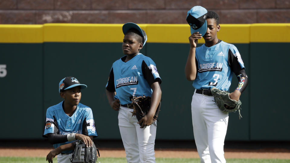 Curacao's Keven Rosina (7) stands in the outfield with Farens Wooter, left, and Nathan Castillo (3) after being taken out of the Little League World Series Championship baseball game pitching against River Ridge, Louisiana, in the fifth inning in South Williamsport, Pa., Sunday, Aug. 25, 2019. (AP Photo/Tom E. Puskar)