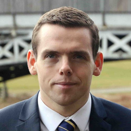 A head and shoulders photo of a young Douglas Ross smiling