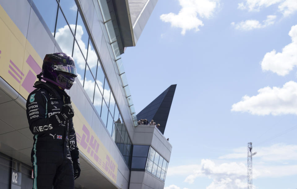 Mercedes driver Lewis Hamilton of Britain celebrates after he clocked the fastest time during the qualifying session for the British Formula One Grand Prix at the Silverstone racetrack, Silverstone, England, Saturday, Aug. 1, 2020. The British Formula One Grand Prix will be held on Sunday. (Will Oliver/Pool via AP)