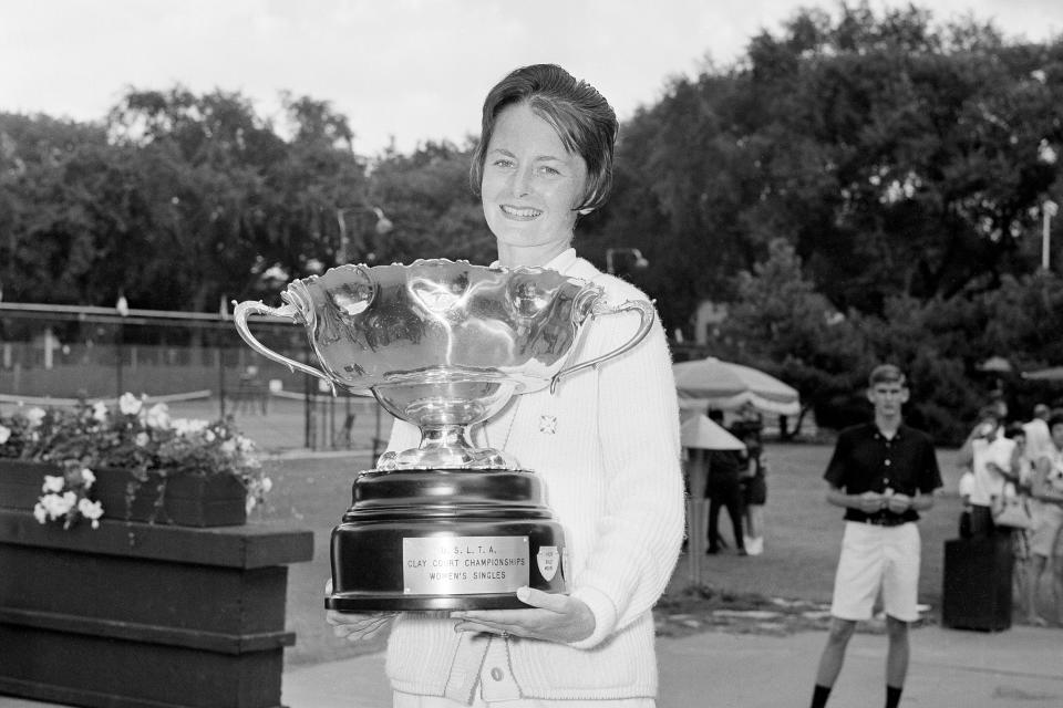 FILE - In this July 21, 1963, file photo, Nancy Richey poses with her trophy after winning the women's singles title of the National Clay Court tennis championships in River Forest, Ill. It’s the 50th anniversary of Billie Jean King and eight other women breaking away from the tennis establishment in 1970 and signing a $1 contract to form the Virginia Slims circuit. That led to the WTA Tour, which offers millions in prize money. Richey was one of the nine. (AP Photo/LO, File)