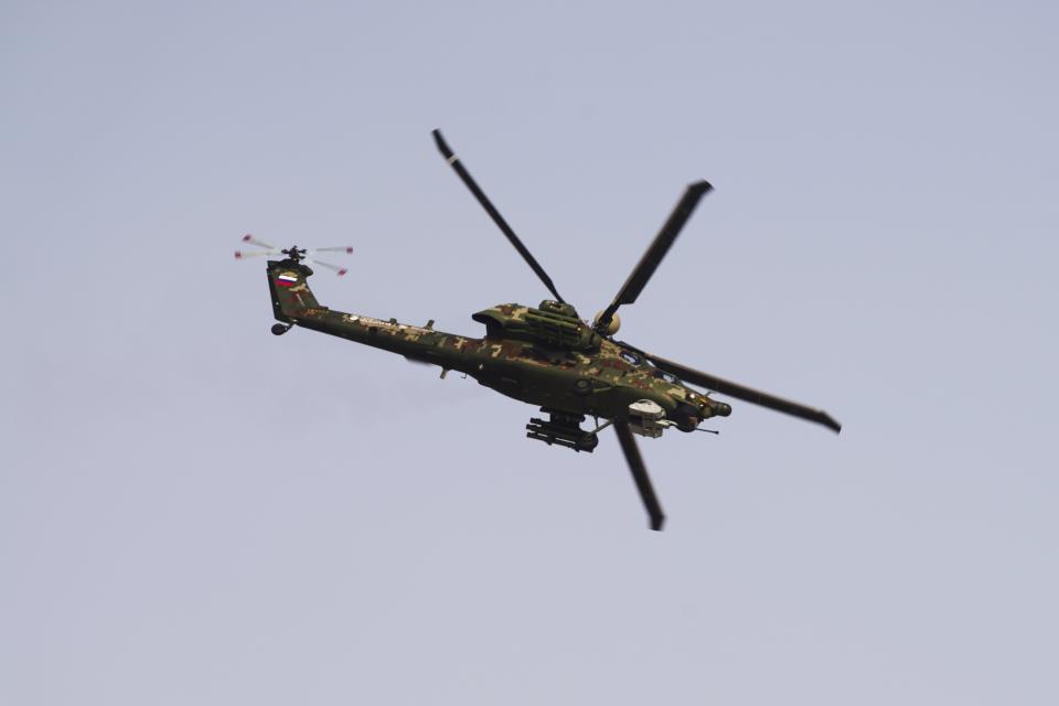 A Russian Mil MI-28 attack helicopter flies at the Dubai Air Show in Dubai, United Arab Emirates, Wednesday, Nov. 17, 2021. (AP Photo/Jon Gambrell)