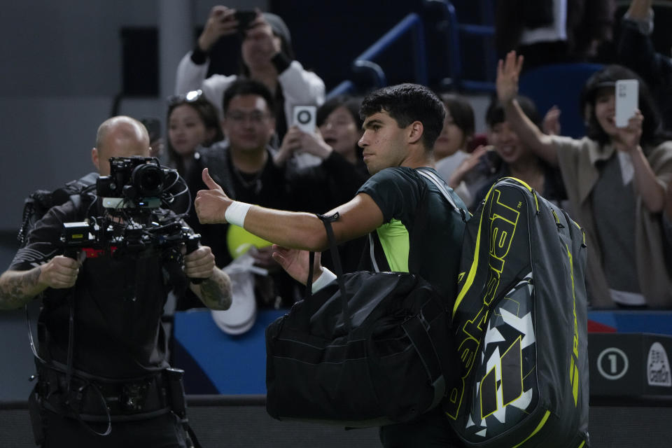 Carlos Alcaraz of Spain gestures as he leaves the court after defeated by Grigor Dimitrov of Bulgaria in the 4th round of the men's singles match in the Shanghai Masters tennis tournament at Qizhong Forest Sports City Tennis Center in Shanghai, China, Wednesday, Oct. 11, 2023. (AP Photo/Andy Wong)