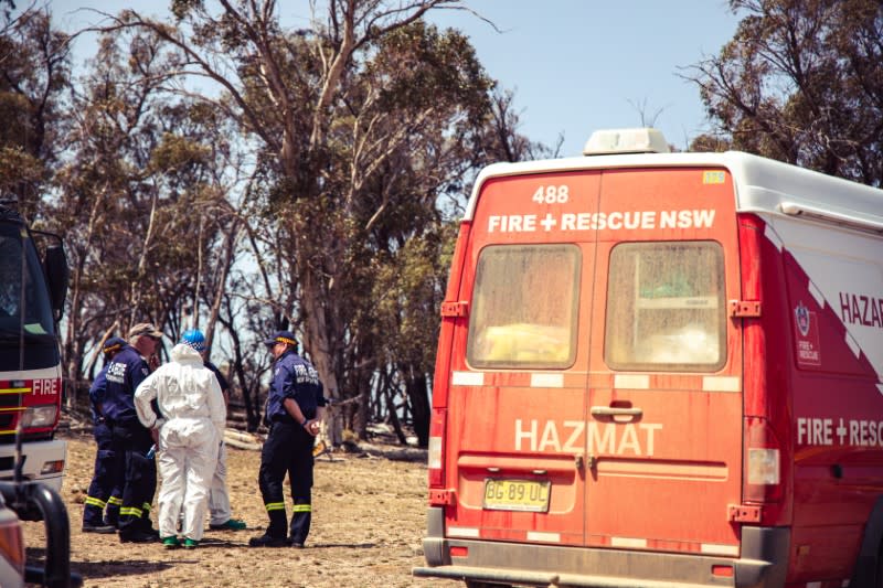 Fire and rescue personnel are seen following the crash of a C-130 air tanker plane after dropping fire retardant, in this January 24, 2020 picture obtained from social media