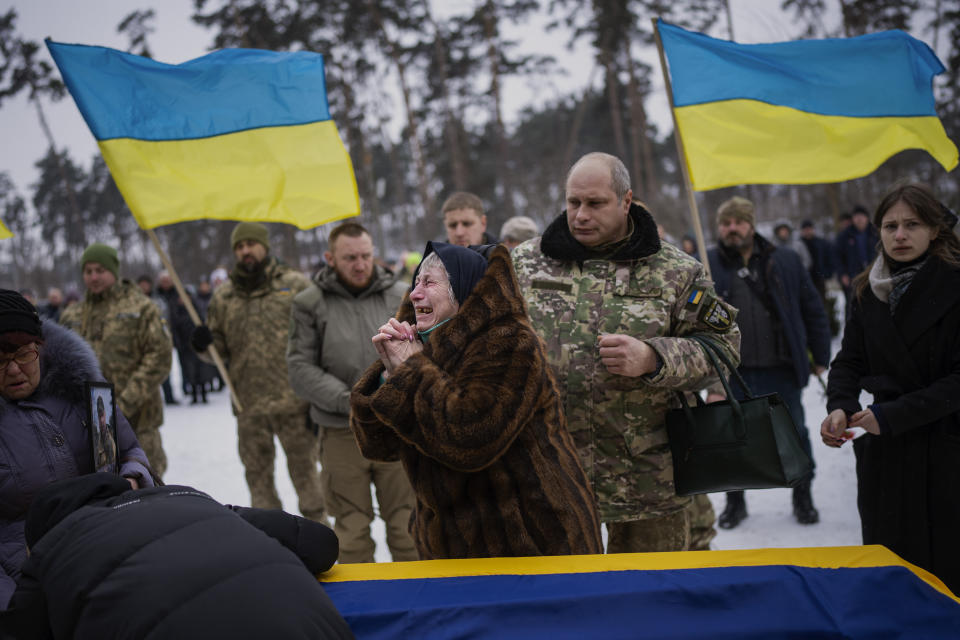 Nina Nikiforovа, 80, cries next to the body of her son Oleg Kunynets, a Ukrainian military serviceman who was killed in the east of the country, during his funeral in Kyiv, Ukraine, Saturday, Feb. 11, 2023. (AP Photo/Emilio Morenatti)