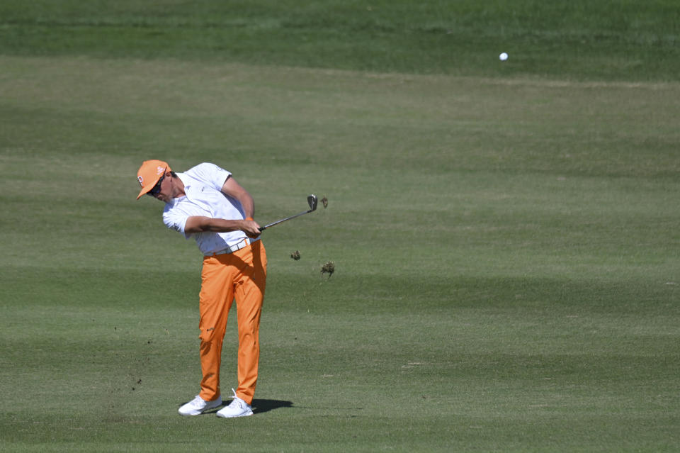 Rickie Fowler makes his second shot on the first hole during final round of the CJ Cup golf tournament, Sunday, Oct. 17, 2021, in Las Vegas. (AP Photo/David Becker)