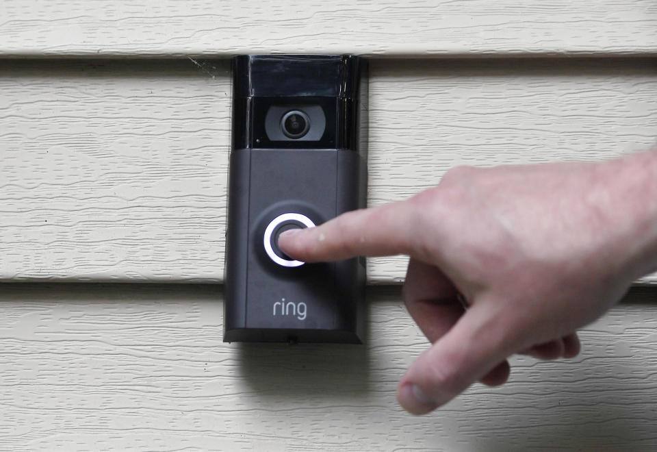 In this Tuesday, July 16, 2019, photo, Ernie Field pushes the doorbell on his Ring doorbell camera at his home in Wolcott, Conn. Police departments around the country are partnering with the doorbell camera company Ring in an effort to fight crime and create a sort of modern-day neighborhood watch. (AP Photo/Jessica Hill)