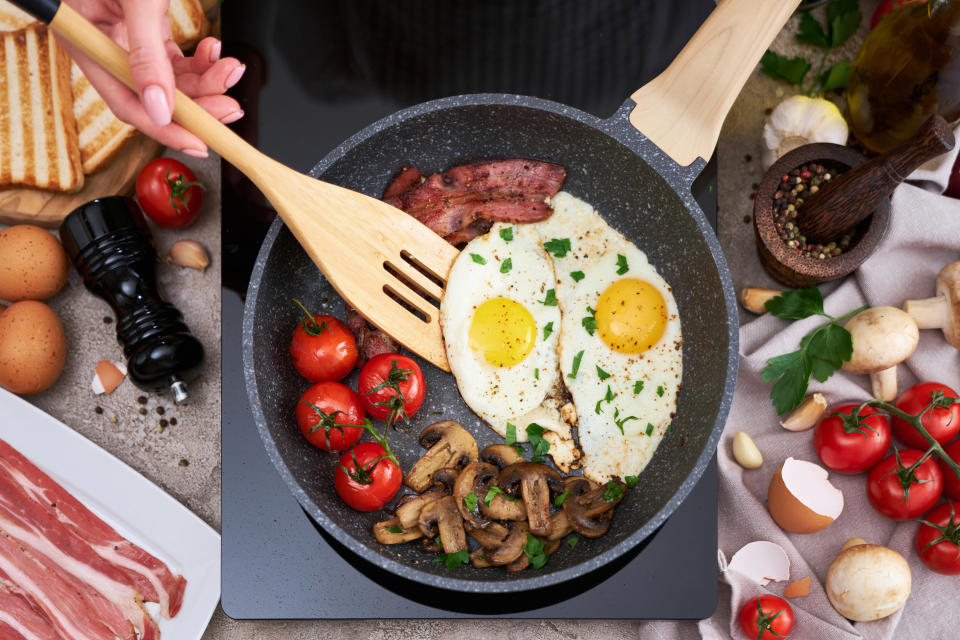 someone cooking on an induction cooktop