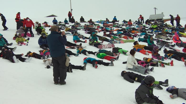 Skiers and boarders lie down for a world record attempt at Spring Hill