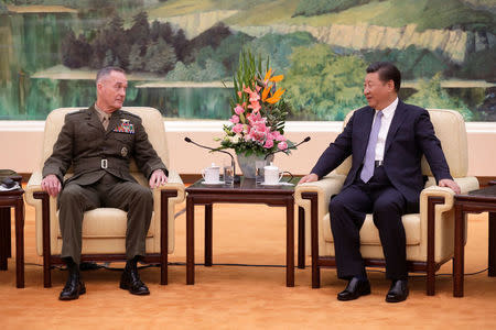 U.S. Chairman of the Joint Chiefs of Staff Gen. Joseph Dunford chats with President Xi Jinping during a meeting at the Great Hall of the People in Beijing, China August 17, 2017. REUTERS/Andy Wong/Pool
