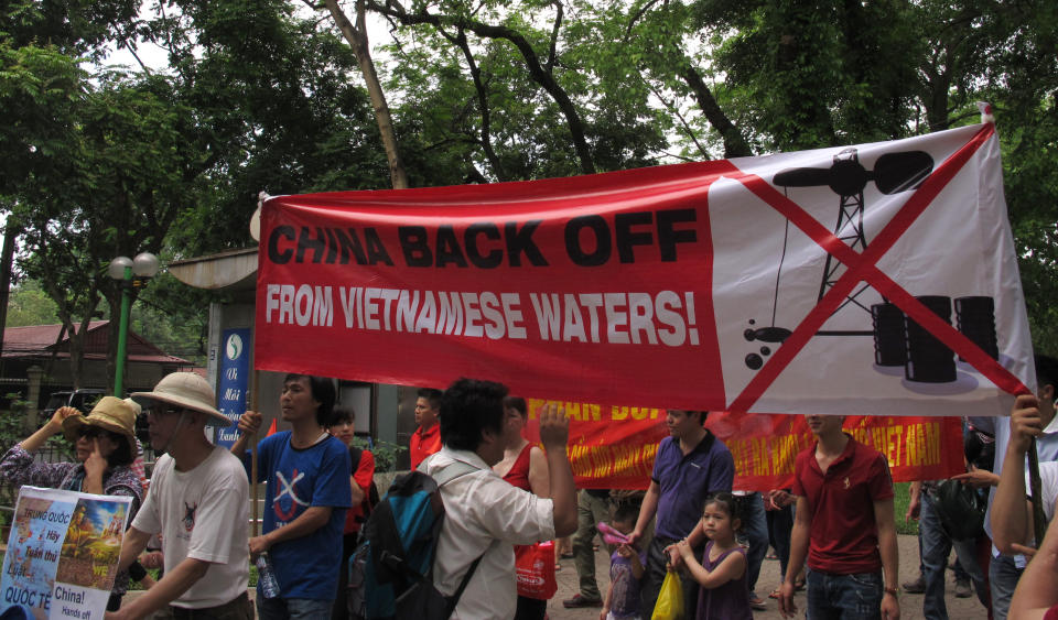 Vietnamese protest outside the Chinese Embassy on Sunday, May 11, 2014 in Hanoi, Vietnam, against Beijing's deployment of an oil rig in the contested waters of the South China Sea. The deployment of the rig has a triggered a tense standoff in the ocean and raised fears of confrontation between the neighboring  countries. (AP Photo/Chris Brummitt)